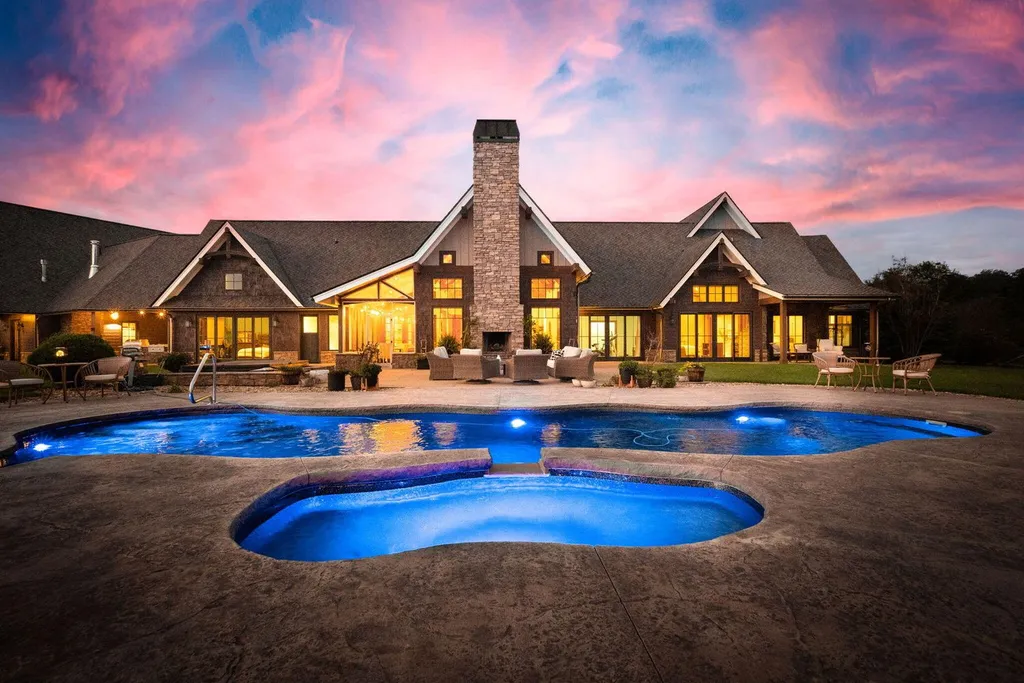 180 Riverwalk Court Home in Greeneville, Tennessee. Discover your dream oasis on this breathtaking 5-acre riverfront property! This extraordinary 7,000+ sqft home seamlessly blends transitional architecture with rustic charm, creating a captivating retreat. The striking blend of stone and poplar wood siding on the exterior exudes warmth and charm.
