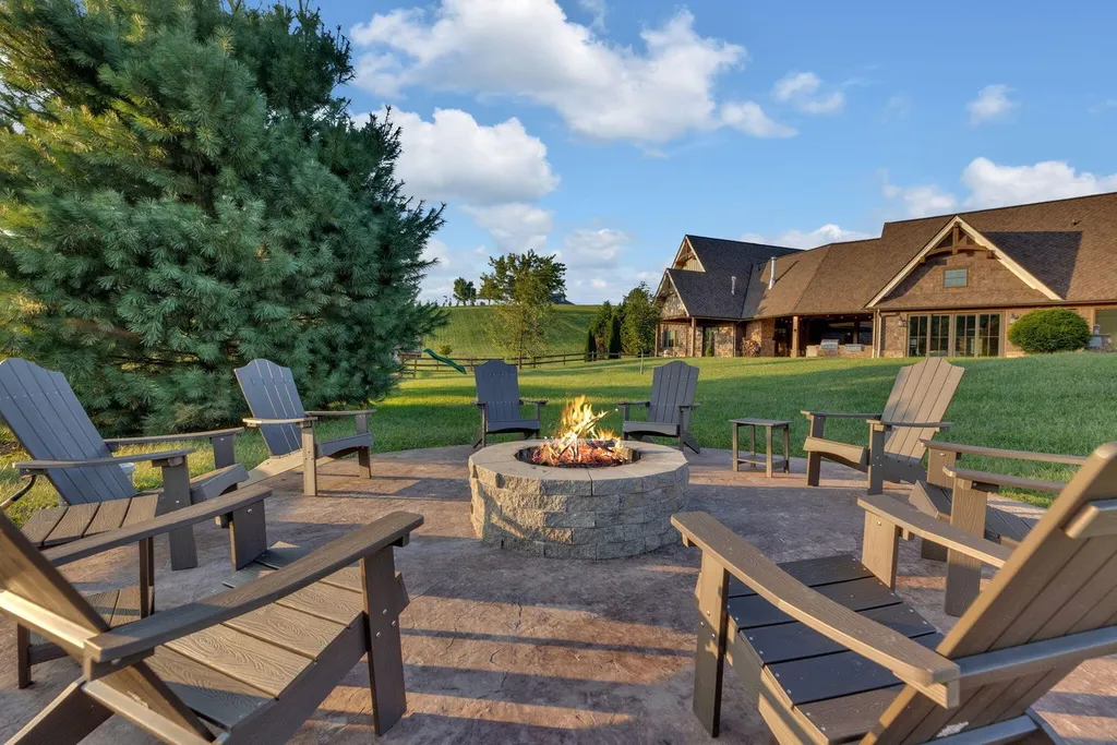 180 Riverwalk Court Home in Greeneville, Tennessee. Discover your dream oasis on this breathtaking 5-acre riverfront property! This extraordinary 7,000+ sqft home seamlessly blends transitional architecture with rustic charm, creating a captivating retreat. The striking blend of stone and poplar wood siding on the exterior exudes warmth and charm.