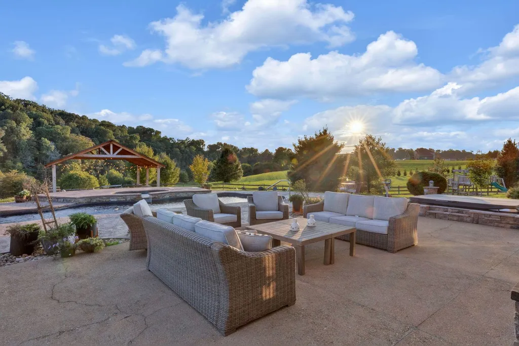 180 Riverwalk Court Home in Greeneville, Tennessee. Discover your dream oasis on this breathtaking 5-acre riverfront property! This extraordinary 7,000+ sqft home seamlessly blends transitional architecture with rustic charm, creating a captivating retreat. The striking blend of stone and poplar wood siding on the exterior exudes warmth and charm.