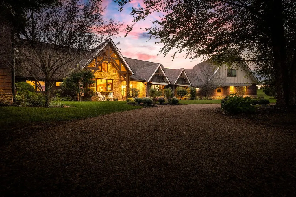 180 Riverwalk Court Home in Greeneville, Tennessee. Discover your dream oasis on this breathtaking 5-acre riverfront property! This extraordinary 7,000+ sqft home seamlessly blends transitional architecture with rustic charm, creating a captivating retreat. The striking blend of stone and poplar wood siding on the exterior exudes warmth and charm.