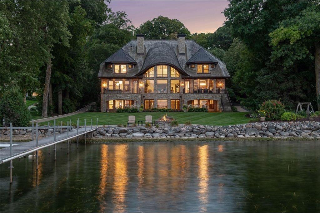 20630 Linwood Road Home in Excelsior, Minnesota. Welcome to 20630 Linwood Road, an exquisite gated estate nestled on two acres in the heart of Cottagewood USA, boasting 134 feet of premium northwest-facing, sandy, level lakeshore on Lake Minnetonka.