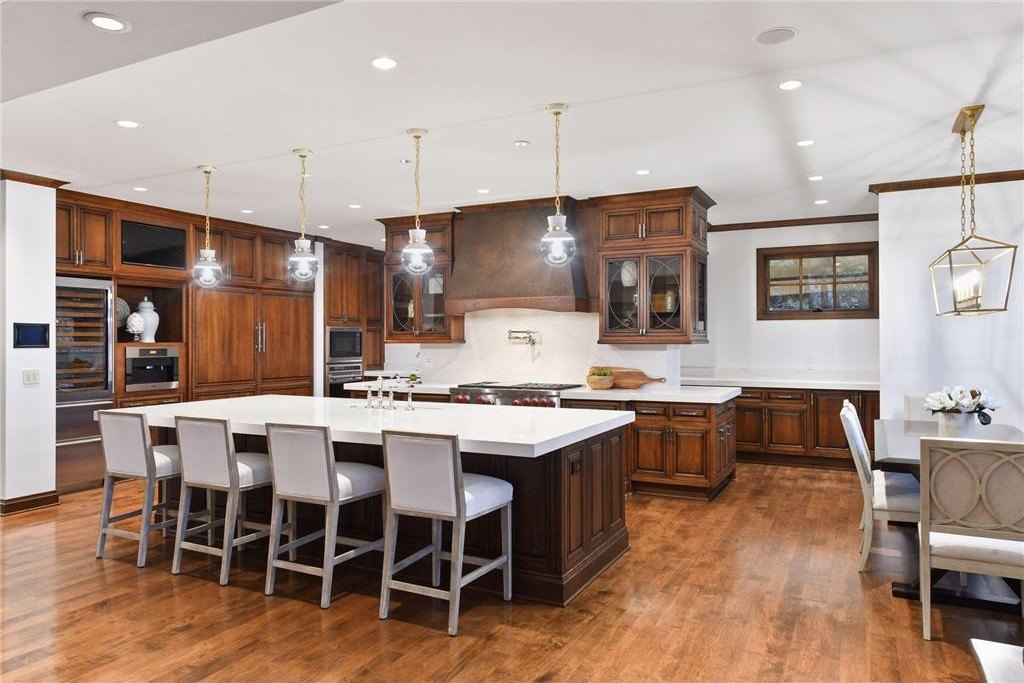20630 Linwood Road Home in Excelsior, Minnesota. Welcome to 20630 Linwood Road, an exquisite gated estate nestled on two acres in the heart of Cottagewood USA, boasting 134 feet of premium northwest-facing, sandy, level lakeshore on Lake Minnetonka.