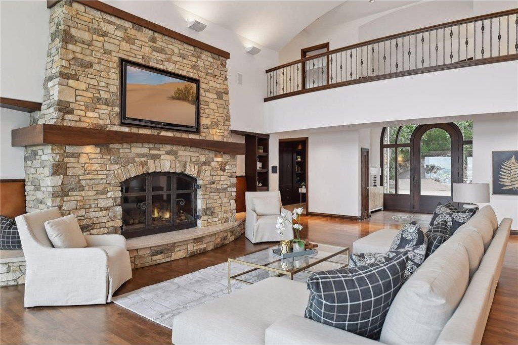 20630 Linwood Road Home in Excelsior, Minnesota. Welcome to 20630 Linwood Road, an exquisite gated estate nestled on two acres in the heart of Cottagewood USA, boasting 134 feet of premium northwest-facing, sandy, level lakeshore on Lake Minnetonka.
