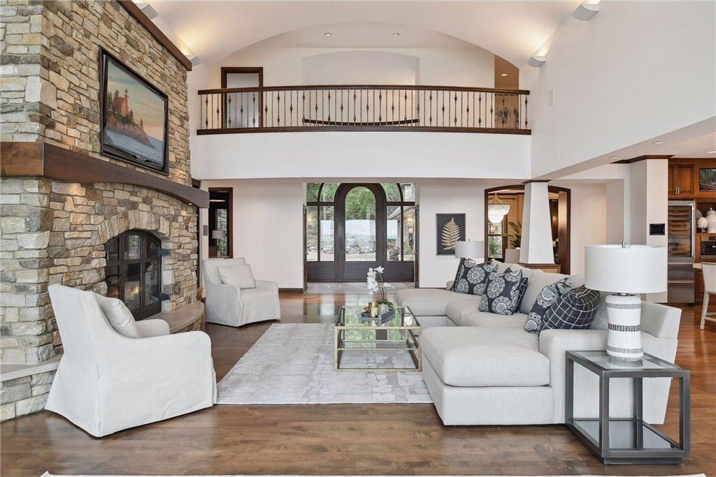 20630 Linwood Road Home in Excelsior, Minnesota. Welcome to 20630 Linwood Road, an exquisite gated estate nestled on two acres in the heart of Cottagewood USA, boasting 134 feet of premium northwest-facing, sandy, level lakeshore on Lake Minnetonka.