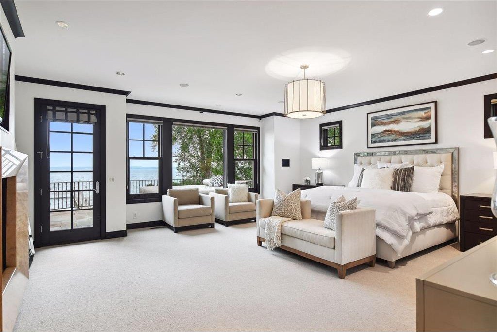20630 Linwood Road Home in Excelsior, Minnesota. Welcome to 20630 Linwood Road, an exquisite gated estate nestled on two acres in the heart of Cottagewood USA, boasting 134 feet of premium northwest-facing, sandy, level lakeshore on Lake Minnetonka.