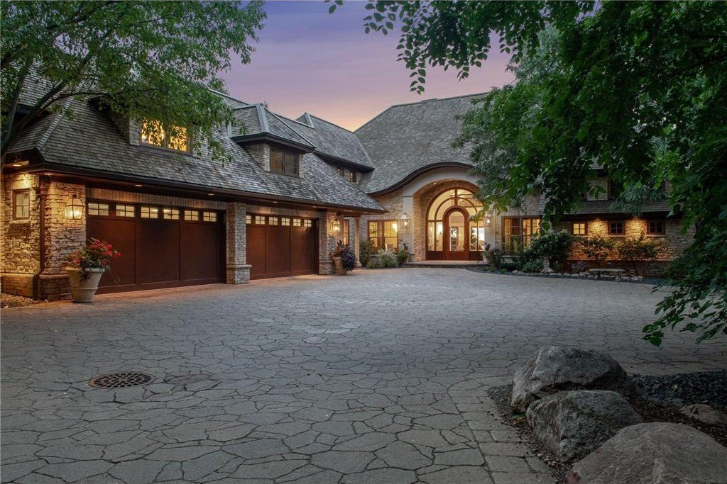 20630 Linwood Road Home in Excelsior, Minnesota. Welcome to 20630 Linwood Road, an exquisite gated estate nestled on two acres in the heart of Cottagewood USA, boasting 134 feet of premium northwest-facing, sandy, level lakeshore on Lake Minnetonka.