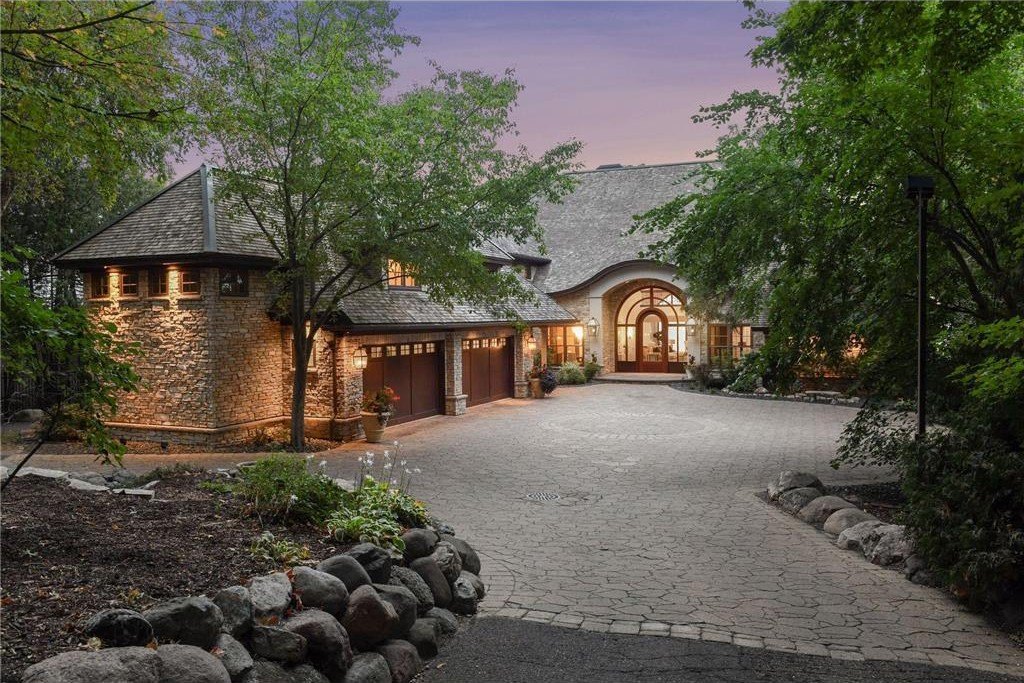 20630 Linwood Road Home in Excelsior, Minnesota. Welcome to 20630 Linwood Road, an exquisite gated estate nestled on two acres in the heart of Cottagewood USA, boasting 134 feet of premium northwest-facing, sandy, level lakeshore on Lake Minnetonka.