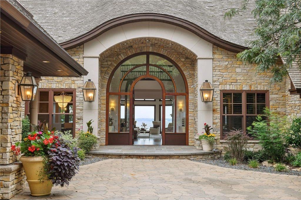 20630 Linwood Road Home in Excelsior, Minnesota. Welcome to 20630 Linwood Road, an exquisite gated estate nestled on two acres in the heart of Cottagewood USA, boasting 134 feet of premium northwest-facing, sandy, level lakeshore on Lake Minnetonka.