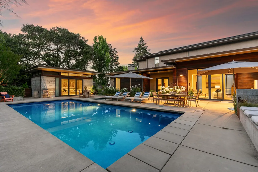 2140 Forest View Avenue Home in Hillsborough, California. Step into the future with this 2016-built contemporary masterpiece located on a premier street in lower North Hillsborough. Designed by architect Dan Phipps and constructed by Toboni Builders, this home is a model of sustainable living with features like solar power, radiant-heated concrete or oak floors, EV wiring, and a radiant deck-heated saltwater pool, all situated on just over half an acre.