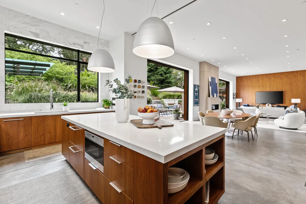 2140 Forest View Avenue Home in Hillsborough, California. Step into the future with this 2016-built contemporary masterpiece located on a premier street in lower North Hillsborough. Designed by architect Dan Phipps and constructed by Toboni Builders, this home is a model of sustainable living with features like solar power, radiant-heated concrete or oak floors, EV wiring, and a radiant deck-heated saltwater pool, all situated on just over half an acre.