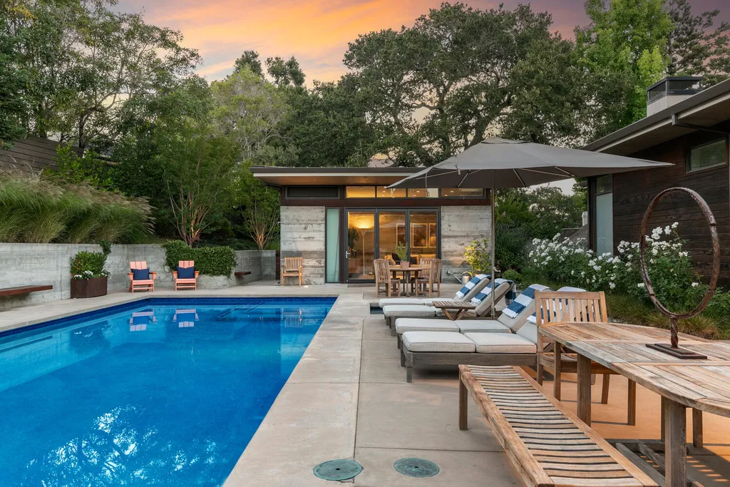 2140 Forest View Avenue Home in Hillsborough, California. Step into the future with this 2016-built contemporary masterpiece located on a premier street in lower North Hillsborough. Designed by architect Dan Phipps and constructed by Toboni Builders, this home is a model of sustainable living with features like solar power, radiant-heated concrete or oak floors, EV wiring, and a radiant deck-heated saltwater pool, all situated on just over half an acre.