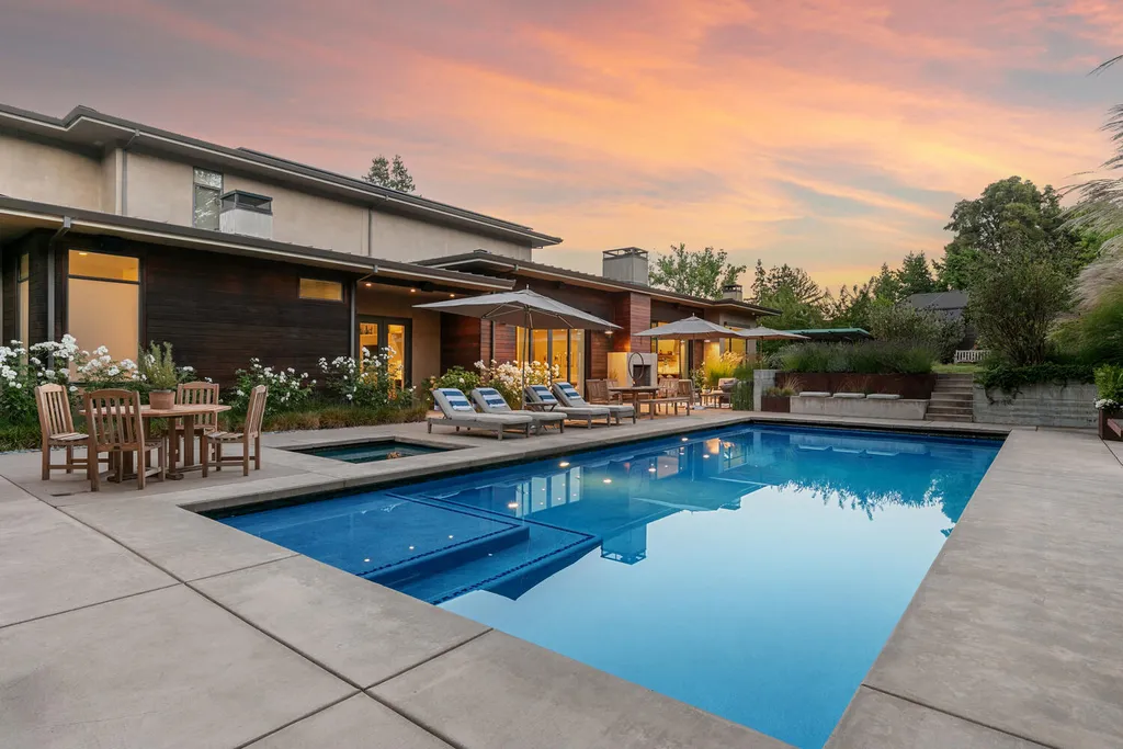 2140 Forest View Avenue Home in Hillsborough, California. Step into the future with this 2016-built contemporary masterpiece located on a premier street in lower North Hillsborough. Designed by architect Dan Phipps and constructed by Toboni Builders, this home is a model of sustainable living with features like solar power, radiant-heated concrete or oak floors, EV wiring, and a radiant deck-heated saltwater pool, all situated on just over half an acre.