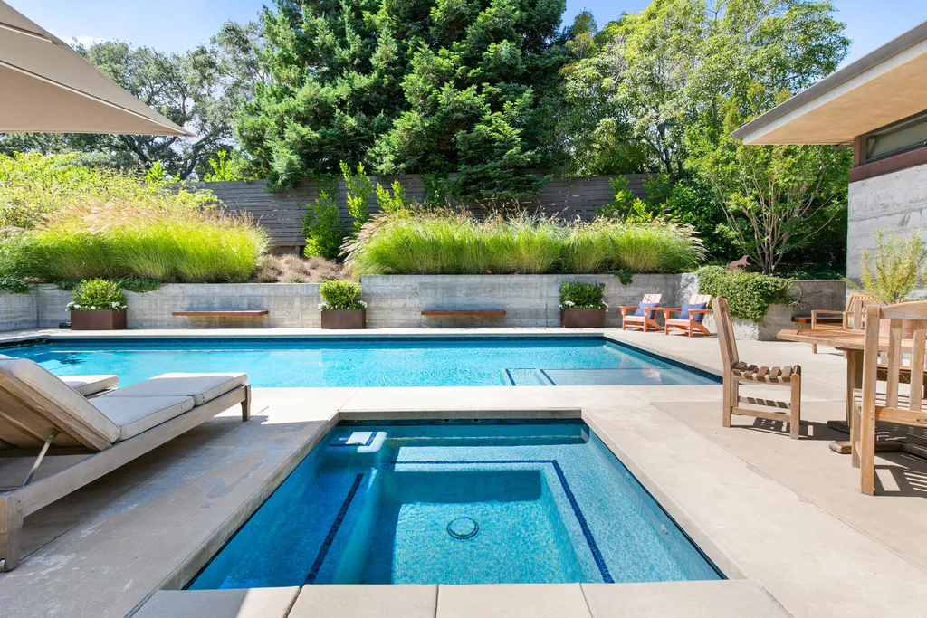 2140 Forest View Avenue Home in Hillsborough, California. Step into the future with this 2016-built contemporary masterpiece located on a premier street in lower North Hillsborough. Designed by architect Dan Phipps and constructed by Toboni Builders, this home is a model of sustainable living with features like solar power, radiant-heated concrete or oak floors, EV wiring, and a radiant deck-heated saltwater pool, all situated on just over half an acre.