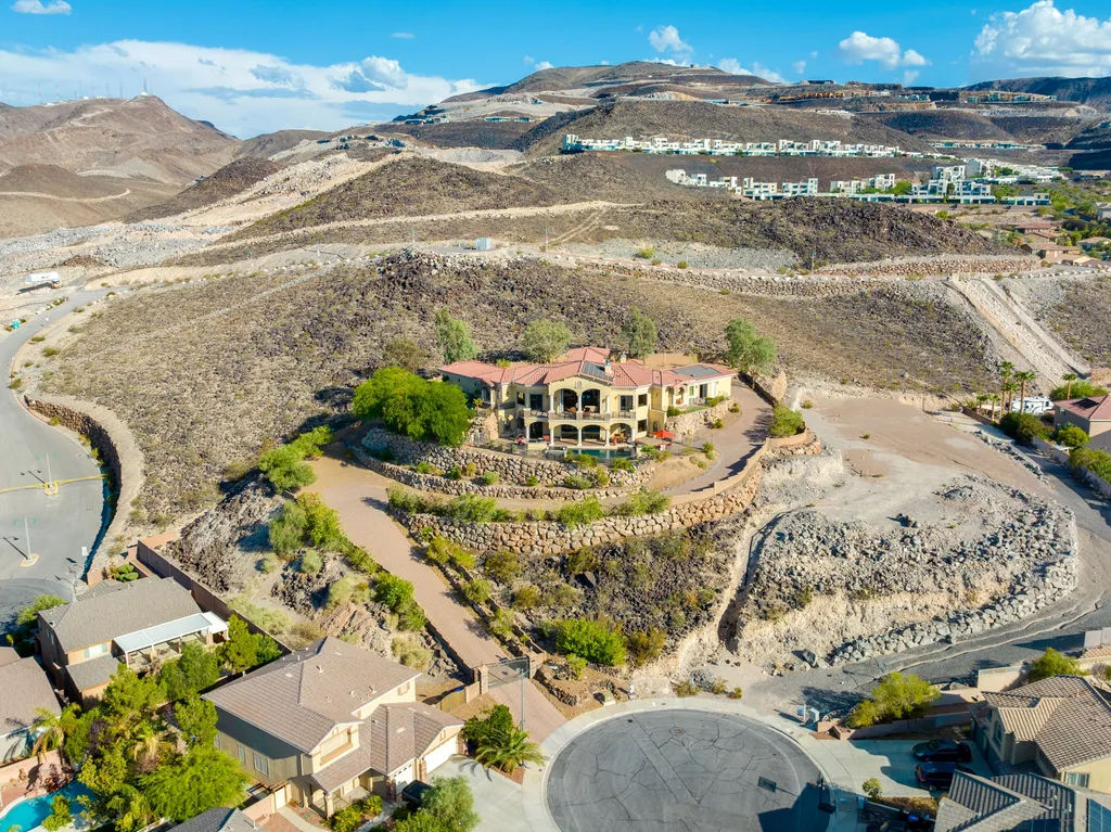 232 Valare Street Home in Henderson, Nevada. Discover the epitome of luxury living in this custom-built split-level home in Las Vegas. With stunning city views, lavish amenities, and meticulous attention to detail, this residence offers the ultimate in upscale living. From the private gated entrance to the infinity pool and spa overlooking the city, this Las Vegas dream home redefines luxury living.