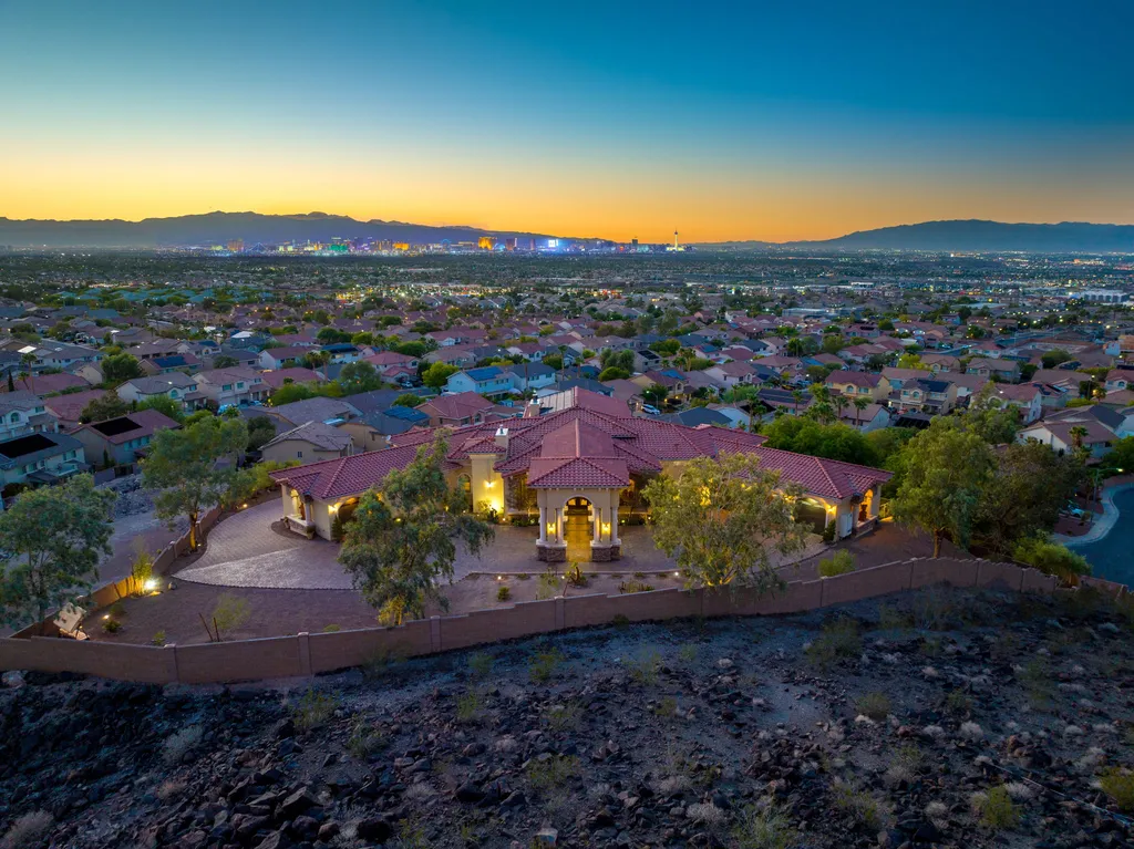 232 Valare Street Home in Henderson, Nevada. Discover the epitome of luxury living in this custom-built split-level home in Las Vegas. With stunning city views, lavish amenities, and meticulous attention to detail, this residence offers the ultimate in upscale living. From the private gated entrance to the infinity pool and spa overlooking the city, this Las Vegas dream home redefines luxury living.