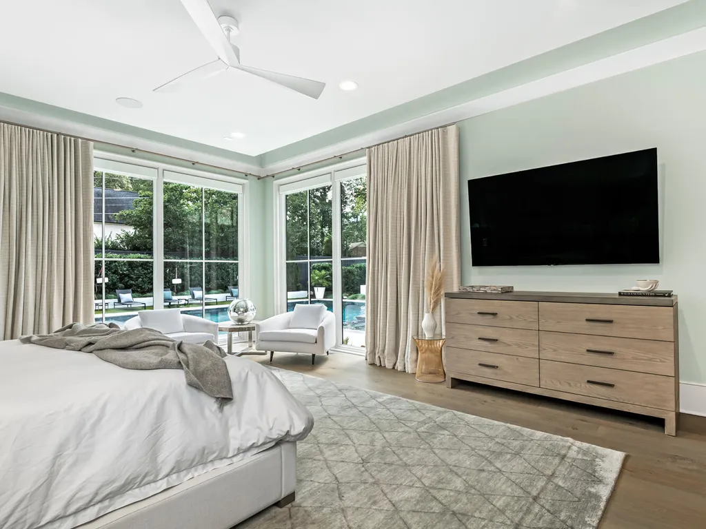 4000 Columbine Circle Home in Charlotte, North Carolina. Discover exquisite luxury living in this custom 5-bedroom, 5.5-bathroom home located in the desirable Foxcroft neighborhood. This David DuBose-designed residence features a gourmet kitchen, light-filled rooms with floor-to-ceiling windows, a spacious primary suite with a large closet, and a beautiful outdoor living space with a pool, spa, and detached garage with a flex space above.