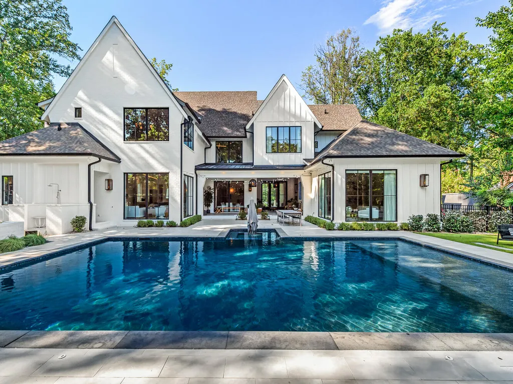 4000 Columbine Circle Home in Charlotte, North Carolina. Discover exquisite luxury living in this custom 5-bedroom, 5.5-bathroom home located in the desirable Foxcroft neighborhood. This David DuBose-designed residence features a gourmet kitchen, light-filled rooms with floor-to-ceiling windows, a spacious primary suite with a large closet, and a beautiful outdoor living space with a pool, spa, and detached garage with a flex space above.