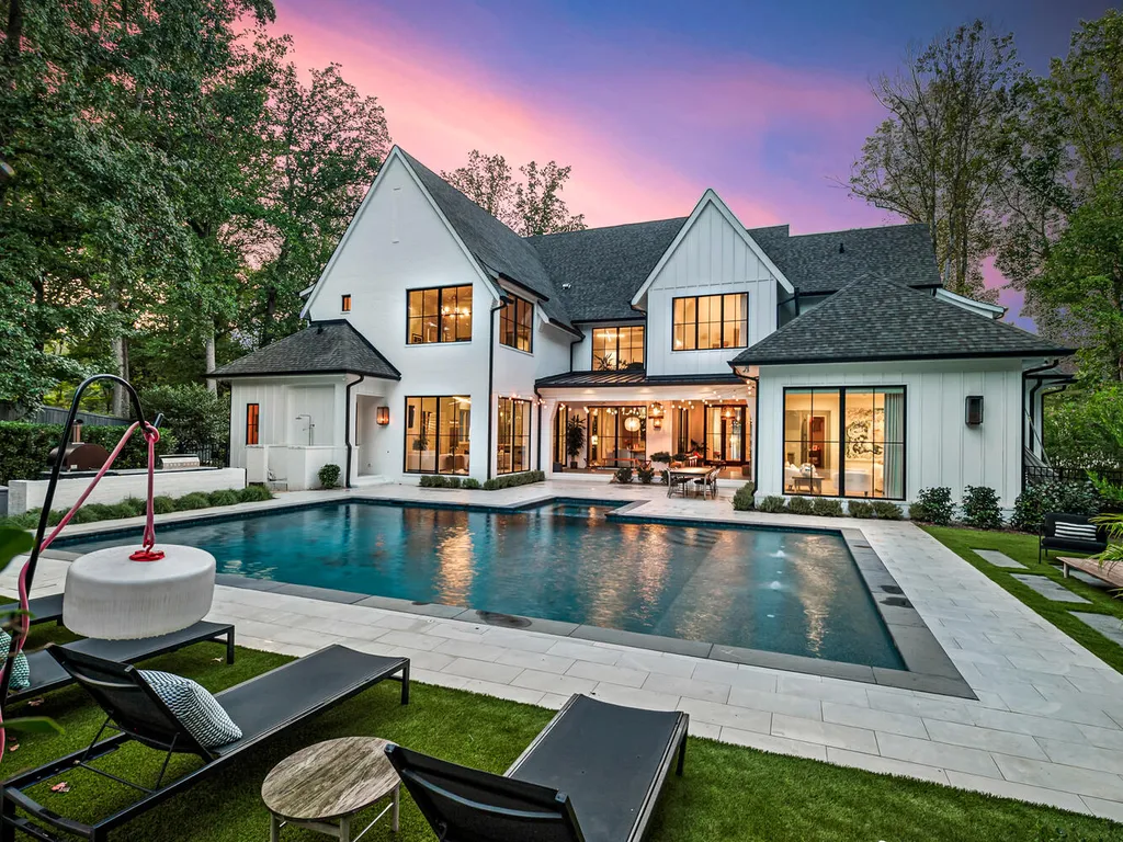 4000 Columbine Circle Home in Charlotte, North Carolina. Discover exquisite luxury living in this custom 5-bedroom, 5.5-bathroom home located in the desirable Foxcroft neighborhood. This David DuBose-designed residence features a gourmet kitchen, light-filled rooms with floor-to-ceiling windows, a spacious primary suite with a large closet, and a beautiful outdoor living space with a pool, spa, and detached garage with a flex space above.