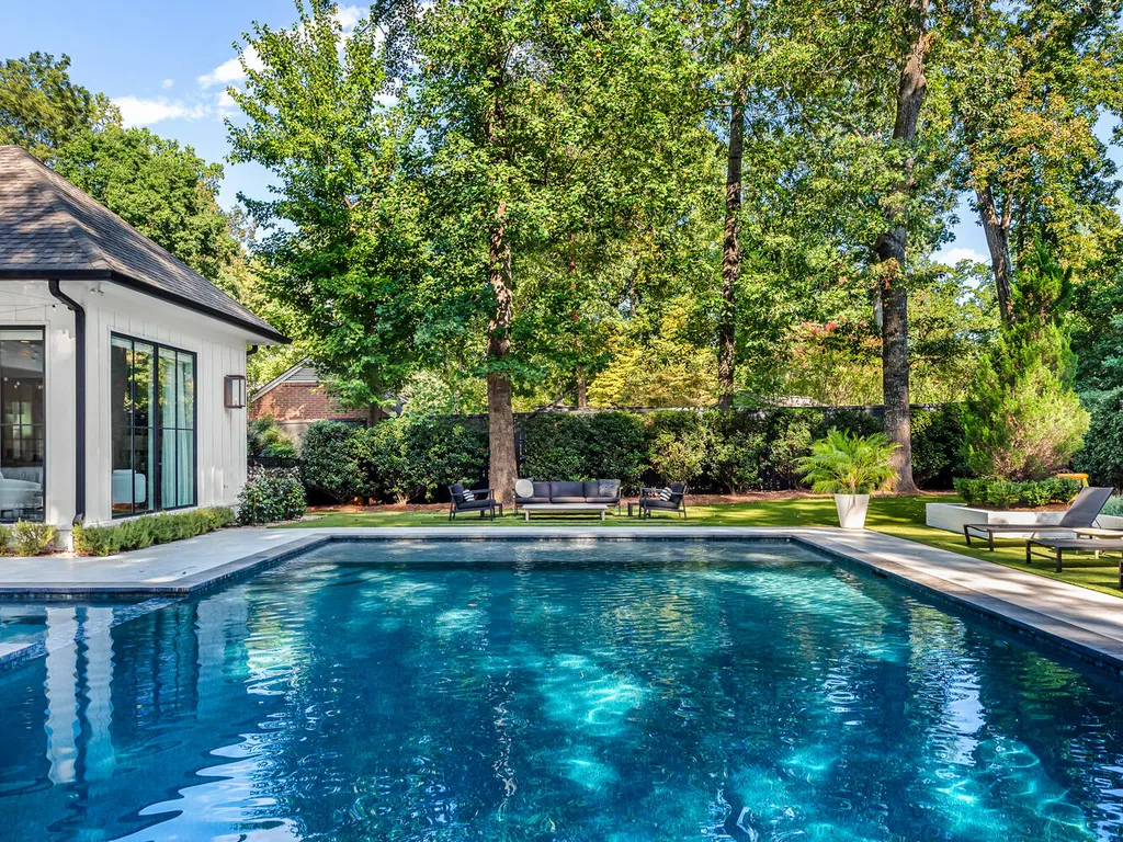 4000 Columbine Circle Home in Charlotte, North Carolina. Discover exquisite luxury living in this custom 5-bedroom, 5.5-bathroom home located in the desirable Foxcroft neighborhood. This David DuBose-designed residence features a gourmet kitchen, light-filled rooms with floor-to-ceiling windows, a spacious primary suite with a large closet, and a beautiful outdoor living space with a pool, spa, and detached garage with a flex space above.