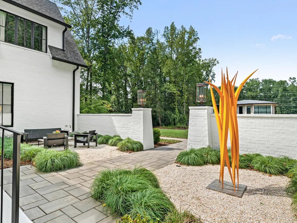 4000 Columbine Circle Home in Charlotte, North Carolina. Discover exquisite luxury living in this custom 5-bedroom, 5.5-bathroom home located in the desirable Foxcroft neighborhood. This David DuBose-designed residence features a gourmet kitchen, light-filled rooms with floor-to-ceiling windows, a spacious primary suite with a large closet, and a beautiful outdoor living space with a pool, spa, and detached garage with a flex space above.