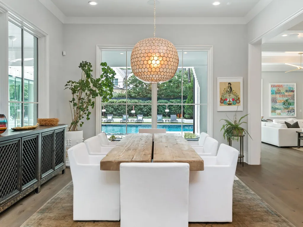 4000 Columbine Circle Home in Charlotte, North Carolina. Discover exquisite luxury living in this custom 5-bedroom, 5.5-bathroom home located in the desirable Foxcroft neighborhood. This David DuBose-designed residence features a gourmet kitchen, light-filled rooms with floor-to-ceiling windows, a spacious primary suite with a large closet, and a beautiful outdoor living space with a pool, spa, and detached garage with a flex space above.
