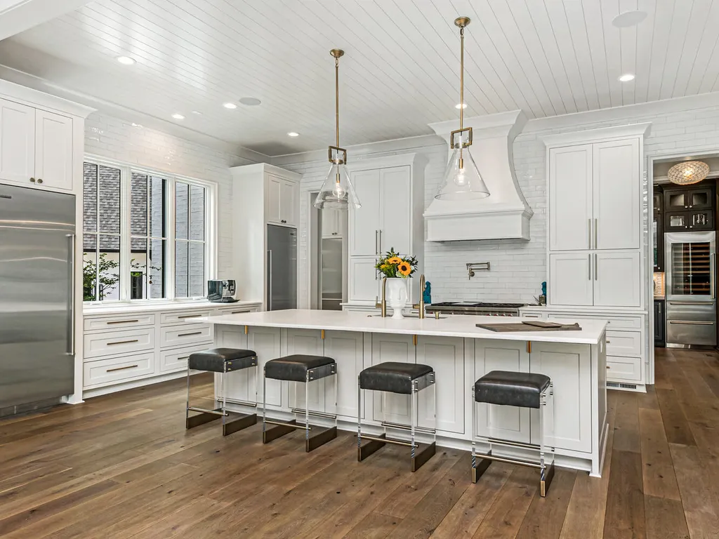 4000 Columbine Circle Home in Charlotte, North Carolina. Discover exquisite luxury living in this custom 5-bedroom, 5.5-bathroom home located in the desirable Foxcroft neighborhood. This David DuBose-designed residence features a gourmet kitchen, light-filled rooms with floor-to-ceiling windows, a spacious primary suite with a large closet, and a beautiful outdoor living space with a pool, spa, and detached garage with a flex space above.