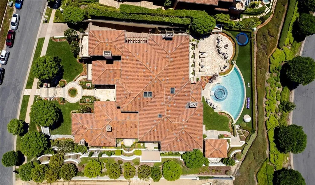 5 Pelicans Drive Home in Newport Coast, California. This stunning Pelican Crest estate is ideally located on one of the most coveted prime view lots in the community. It offers luxury and elegance along with warm and inviting living. The property has 6 bedrooms, 6.5 bathrooms, and a spacious floor plan that is perfect for both intimate living and entertaining. It also features stunning ocean views, a state-of-the-art theater, and a wine cellar.