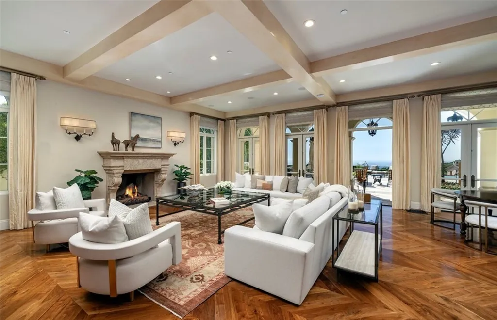 5 Pelicans Drive Home in Newport Coast, California. This stunning Pelican Crest estate is ideally located on one of the most coveted prime view lots in the community. It offers luxury and elegance along with warm and inviting living. The property has 6 bedrooms, 6.5 bathrooms, and a spacious floor plan that is perfect for both intimate living and entertaining. It also features stunning ocean views, a state-of-the-art theater, and a wine cellar.