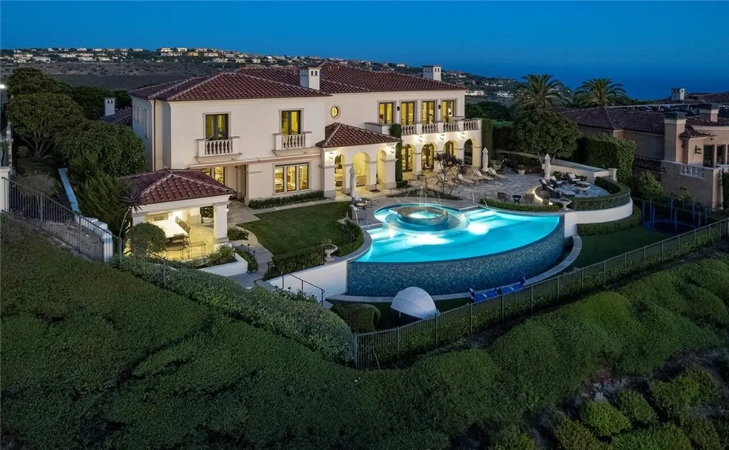 5 Pelicans Drive Home in Newport Coast, California. This stunning Pelican Crest estate is ideally located on one of the most coveted prime view lots in the community. It offers luxury and elegance along with warm and inviting living. The property has 6 bedrooms, 6.5 bathrooms, and a spacious floor plan that is perfect for both intimate living and entertaining. It also features stunning ocean views, a state-of-the-art theater, and a wine cellar.