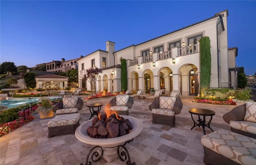 5 Pelicans Drive Home in Newport Coast, California. This stunning Pelican Crest estate is ideally located on one of the most coveted prime view lots in the community. It offers luxury and elegance along with warm and inviting living. The property has 6 bedrooms, 6.5 bathrooms, and a spacious floor plan that is perfect for both intimate living and entertaining. It also features stunning ocean views, a state-of-the-art theater, and a wine cellar.
