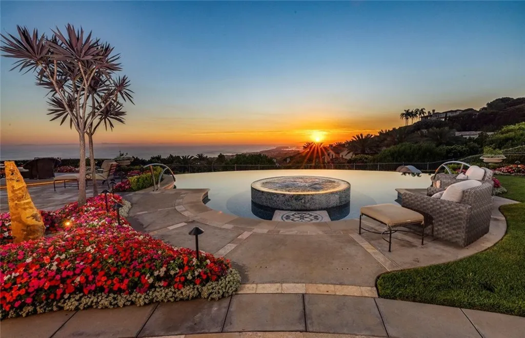 5 Pelicans Drive Home in Newport Coast, California. This stunning Pelican Crest estate is ideally located on one of the most coveted prime view lots in the community. It offers luxury and elegance along with warm and inviting living. The property has 6 bedrooms, 6.5 bathrooms, and a spacious floor plan that is perfect for both intimate living and entertaining. It also features stunning ocean views, a state-of-the-art theater, and a wine cellar.