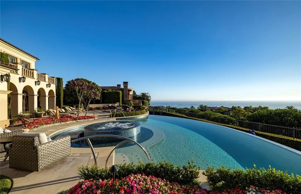 5 Pelicans Drive Home in Newport Coast, California. This stunning Pelican Crest estate is ideally located on one of the most coveted prime view lots in the community. It offers luxury and elegance along with warm and inviting living. The property has 6 bedrooms, 6.5 bathrooms, and a spacious floor plan that is perfect for both intimate living and entertaining. It also features stunning ocean views, a state-of-the-art theater, and a wine cellar.