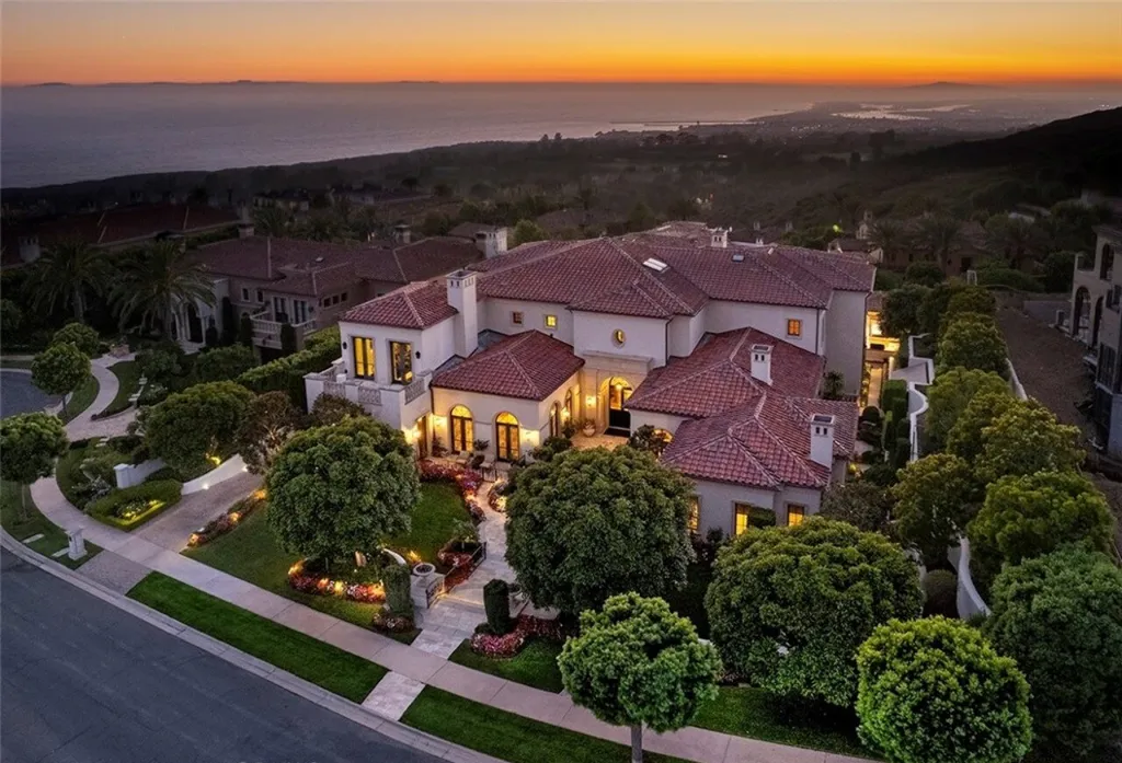 5 Pelicans Drive Home in Newport Coast, California. This stunning Pelican Crest estate is ideally located on one of the most coveted prime view lots in the community. It offers luxury and elegance along with warm and inviting living. The property has 6 bedrooms, 6.5 bathrooms, and a spacious floor plan that is perfect for both intimate living and entertaining. It also features stunning ocean views, a state-of-the-art theater, and a wine cellar.