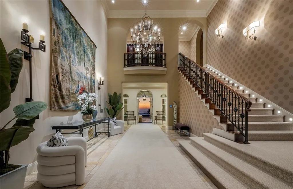 5 Pelicans Drive Home in Newport Coast, California. This stunning Pelican Crest estate is ideally located on one of the most coveted prime view lots in the community. It offers luxury and elegance along with warm and inviting living. The property has 6 bedrooms, 6.5 bathrooms, and a spacious floor plan that is perfect for both intimate living and entertaining. It also features stunning ocean views, a state-of-the-art theater, and a wine cellar.