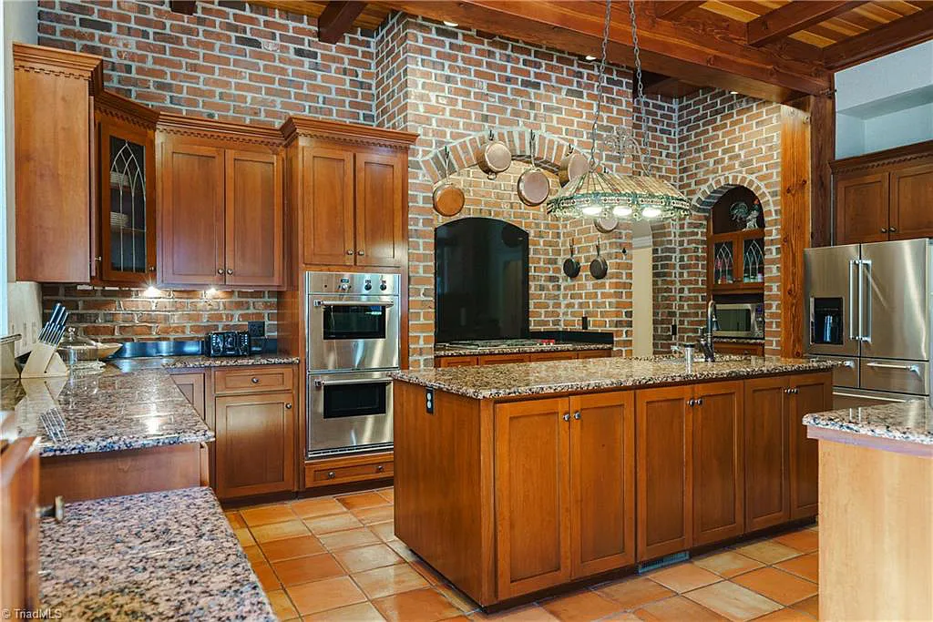 5712 Summit Road Home in Purlear, North Carolina. Explore this exceptional 128+ acre mountain retreat with a gated entrance, a timber-frame home boasting 5 bedrooms and 5 bathrooms. Enjoy the beauty of two spring-fed creeks that encircle the fieldstone exterior of the home.