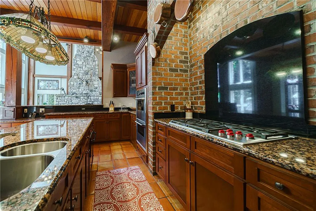 5712 Summit Road Home in Purlear, North Carolina. Explore this exceptional 128+ acre mountain retreat with a gated entrance, a timber-frame home boasting 5 bedrooms and 5 bathrooms. Enjoy the beauty of two spring-fed creeks that encircle the fieldstone exterior of the home.