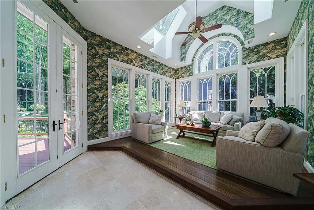 5712 Summit Road Home in Purlear, North Carolina. Explore this exceptional 128+ acre mountain retreat with a gated entrance, a timber-frame home boasting 5 bedrooms and 5 bathrooms. Enjoy the beauty of two spring-fed creeks that encircle the fieldstone exterior of the home.
