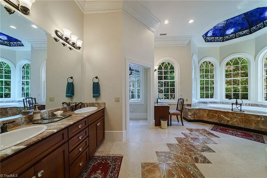 5712 Summit Road Home in Purlear, North Carolina. Explore this exceptional 128+ acre mountain retreat with a gated entrance, a timber-frame home boasting 5 bedrooms and 5 bathrooms. Enjoy the beauty of two spring-fed creeks that encircle the fieldstone exterior of the home.
