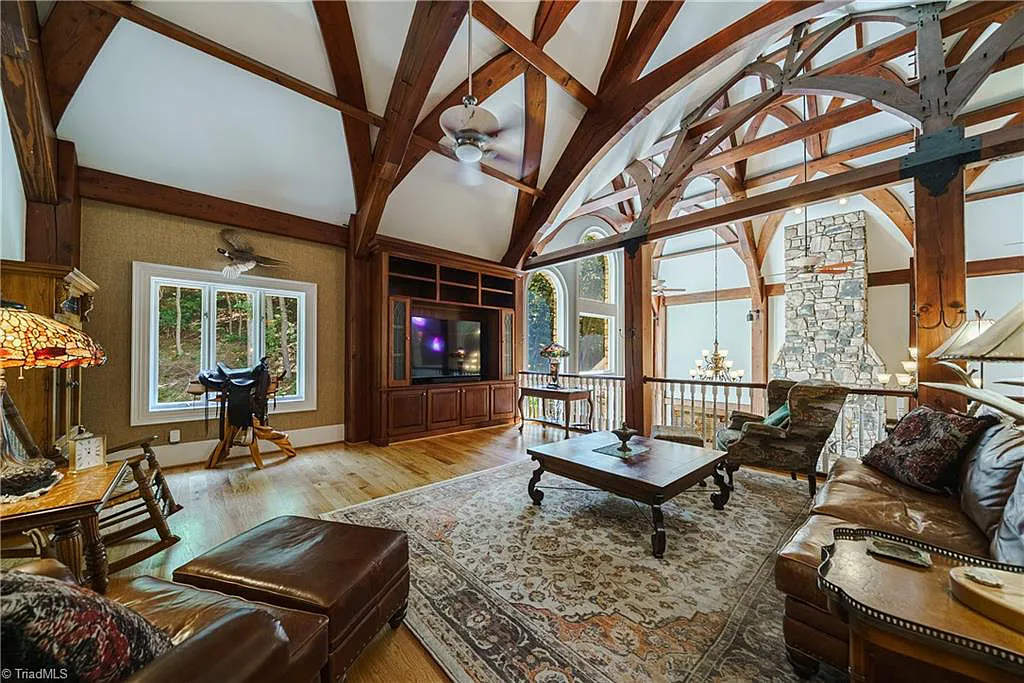 5712 Summit Road Home in Purlear, North Carolina. Explore this exceptional 128+ acre mountain retreat with a gated entrance, a timber-frame home boasting 5 bedrooms and 5 bathrooms. Enjoy the beauty of two spring-fed creeks that encircle the fieldstone exterior of the home.