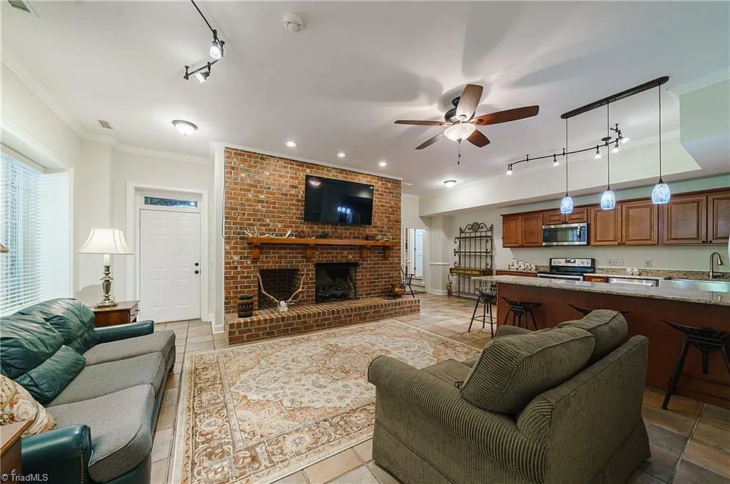 5712 Summit Road Home in Purlear, North Carolina. Explore this exceptional 128+ acre mountain retreat with a gated entrance, a timber-frame home boasting 5 bedrooms and 5 bathrooms. Enjoy the beauty of two spring-fed creeks that encircle the fieldstone exterior of the home.