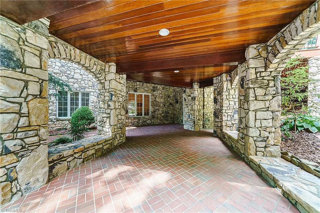 5712 Summit Road Home in Purlear, North Carolina. Explore this exceptional 128+ acre mountain retreat with a gated entrance, a timber-frame home boasting 5 bedrooms and 5 bathrooms. Enjoy the beauty of two spring-fed creeks that encircle the fieldstone exterior of the home.