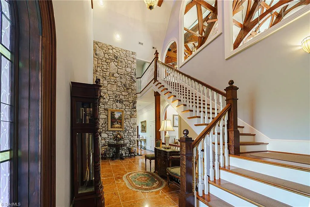 5712 Summit Road Home in Purlear, North Carolina. Explore this exceptional 128+ acre mountain retreat with a gated entrance, a timber-frame home boasting 5 bedrooms and 5 bathrooms. Enjoy the beauty of two spring-fed creeks that encircle the fieldstone exterior of the home.