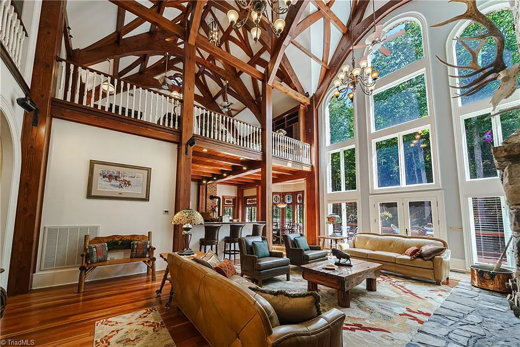5712 Summit Road Home in Purlear, North Carolina. Explore this exceptional 128+ acre mountain retreat with a gated entrance, a timber-frame home boasting 5 bedrooms and 5 bathrooms. Enjoy the beauty of two spring-fed creeks that encircle the fieldstone exterior of the home.