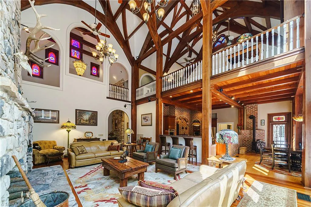 5712 Summit Road Home in Purlear, North Carolina. Explore this exceptional 128+ acre mountain retreat with a gated entrance, a timber-frame home boasting 5 bedrooms and 5 bathrooms. Enjoy the beauty of two spring-fed creeks that encircle the fieldstone exterior of the home.