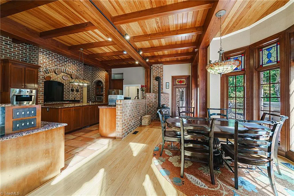 5712 Summit Road Home in Purlear, North Carolina. Explore this exceptional 128+ acre mountain retreat with a gated entrance, a timber-frame home boasting 5 bedrooms and 5 bathrooms. Enjoy the beauty of two spring-fed creeks that encircle the fieldstone exterior of the home.