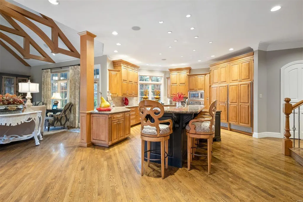 8 Lochinvar Drive Home in Saint Louis, Missouri. This stunning custom built home features a cascading waterfall, spacious living areas, and a finished lower level with every amenity. It is perfect for everyday living and entertaining.