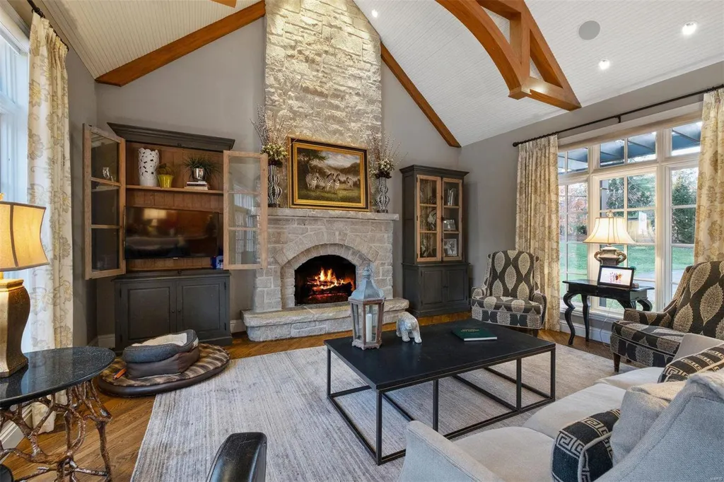 8 Lochinvar Drive Home in Saint Louis, Missouri. This stunning custom built home features a cascading waterfall, spacious living areas, and a finished lower level with every amenity. It is perfect for everyday living and entertaining.