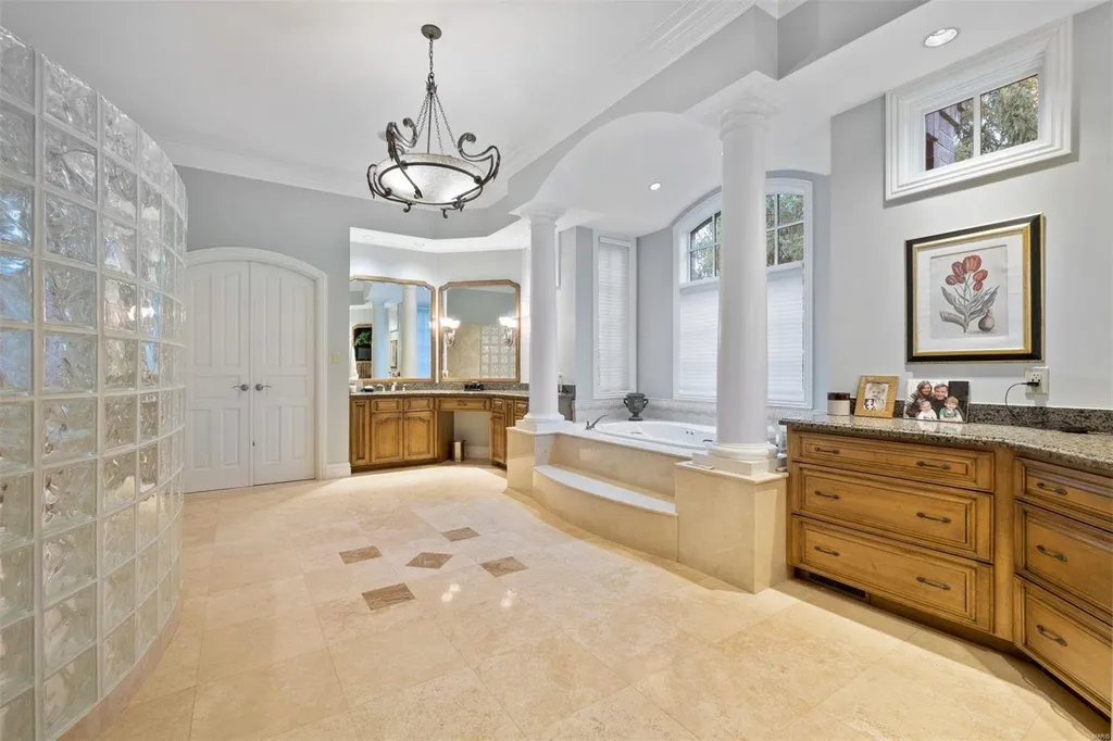 8 Lochinvar Drive Home in Saint Louis, Missouri. This stunning custom built home features a cascading waterfall, spacious living areas, and a finished lower level with every amenity. It is perfect for everyday living and entertaining.