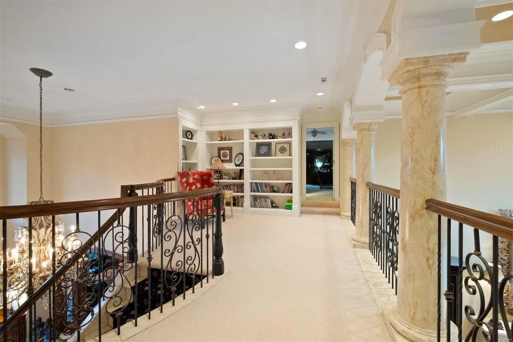 8 Lochinvar Drive Home in Saint Louis, Missouri. This stunning custom built home features a cascading waterfall, spacious living areas, and a finished lower level with every amenity. It is perfect for everyday living and entertaining.