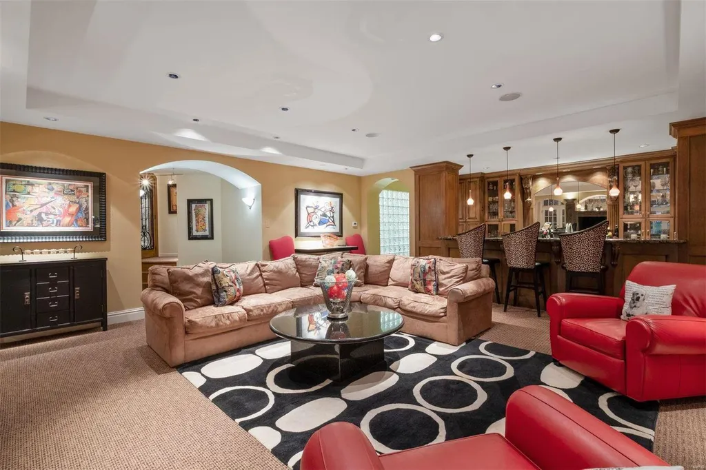 8 Lochinvar Drive Home in Saint Louis, Missouri. This stunning custom built home features a cascading waterfall, spacious living areas, and a finished lower level with every amenity. It is perfect for everyday living and entertaining.